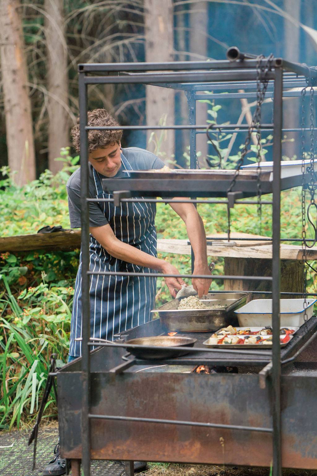 Nomadic's chef cooking in open-air kitchen