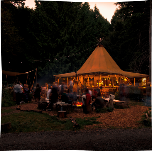 One of our stratus tipis that can comfortably accommodate 100 guests within large wood dining tables, with plenty of storage, lighting, electricity, a field kitchen and composting toilets.